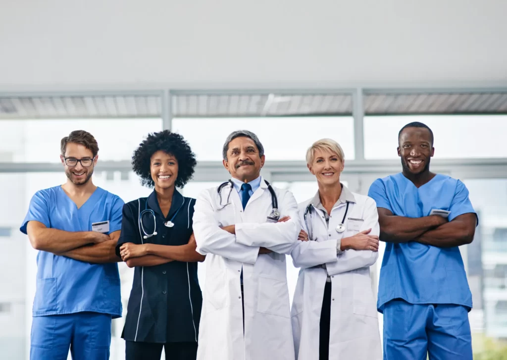 smiling medical team stands in a bright hospital utc